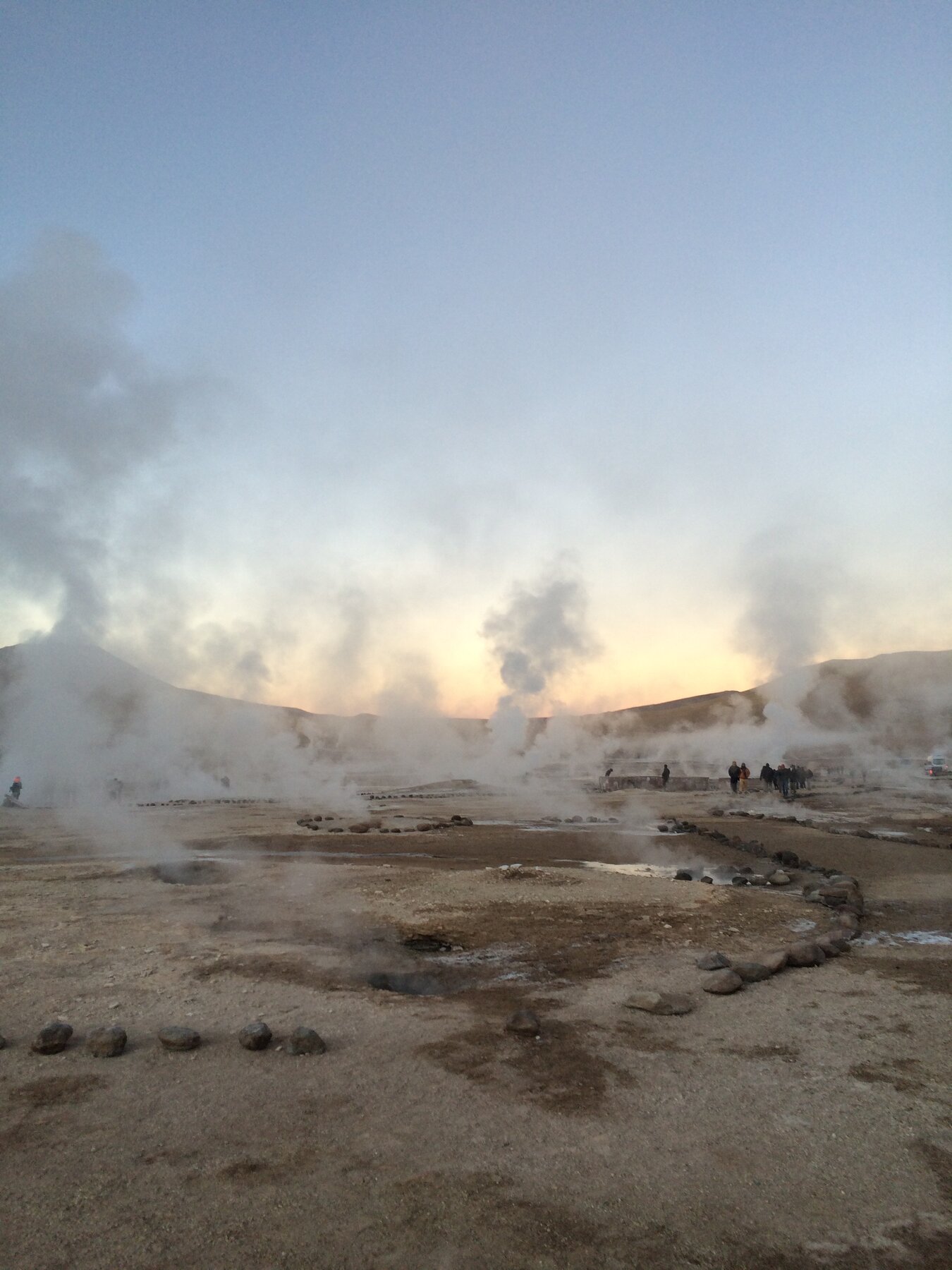 Steam rising over a geothermal field in Iceland